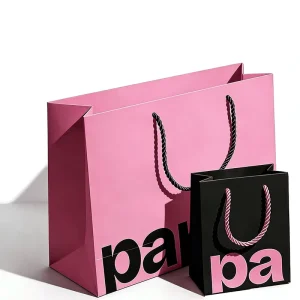 Bold Pink and Black Paper Gift Bags with Custom Logo Print and Twisted Rope Handles for Beauty Boutiques
